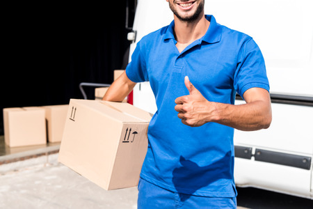 delivery man showing thumb upの写真素材