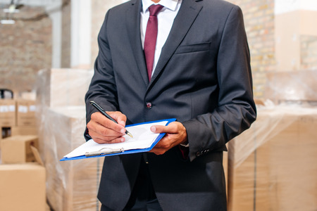 businessman writing on clipboardの写真素材