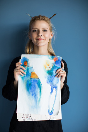 girl holding fashion sketchesの写真素材