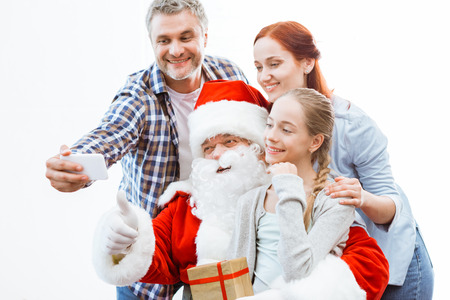 family and santa claus taking selfieの写真素材