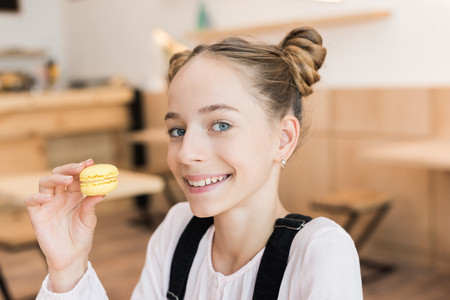 beautiful teen girl with macaroonの写真素材