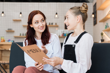 mother and daughter with menu listの写真素材