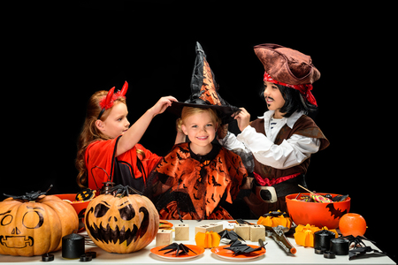 children in halloween costumes with sweetsの写真素材