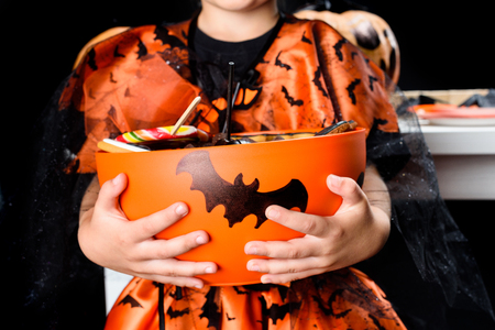 little witch with halloween sweetsの写真素材