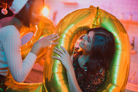 multicultural women with balloonsの写真素材