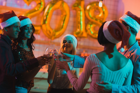 multiethnic friends clinking glasses of champagneの写真素材