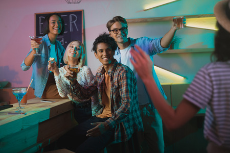 multicultural people greeting friend at party