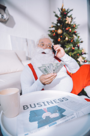 santa claus with cash in handの写真素材