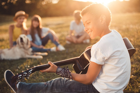 african american teenager playing guitarの写真素材