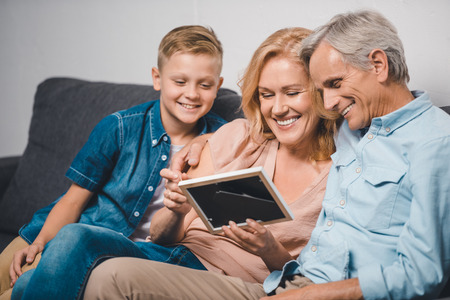 family looking at photo frameの写真素材