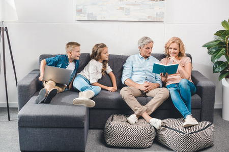family with book and laptopの写真素材