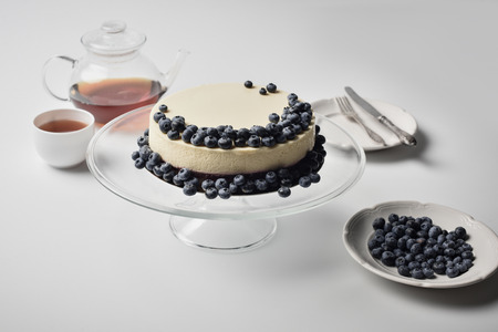 cheesecake with blueberries on glass standの写真素材