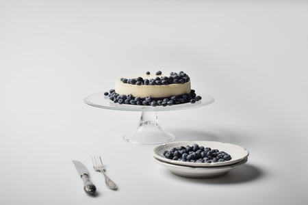 cheesecake with blueberries on glass standの写真素材