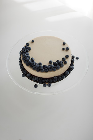 cheesecake with blueberries on glass standの写真素材