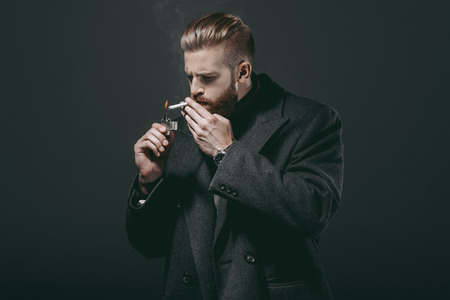 stylish man smoking cigaretteの写真素材