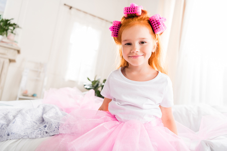 little girl with curlers and tutu tulle skirtの写真素材
