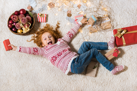 kid lying on floor with giftsの写真素材