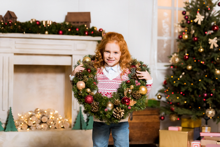 child with christmas wreathの写真素材