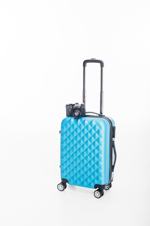 blue luggage bag and photo camera, isolated on whiteの写真素材