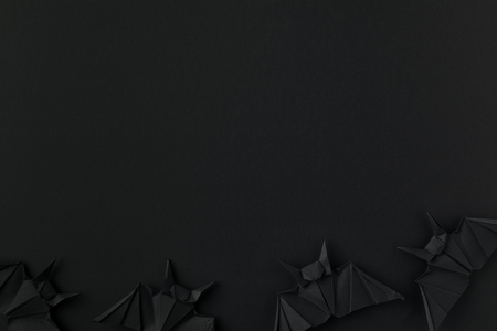 black origami bats for halloween, isolated on black with copy spaceの写真素材