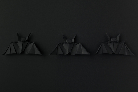 black origami bats for halloween, isolated on black with copy spaceの写真素材