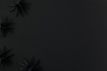 black origami spiders for halloween, isolated on black with copy spaceの写真素材