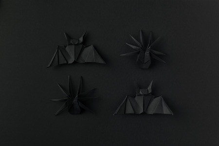 black origami bats and spiders for halloween, isolated on blackの写真素材