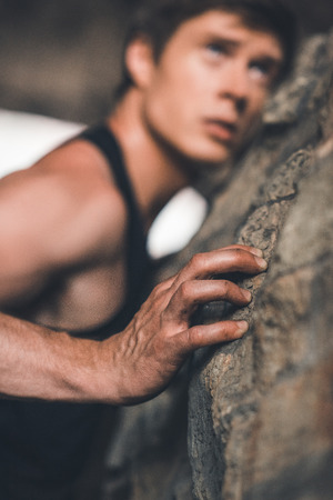 sportive man climbing on ruinsの写真素材