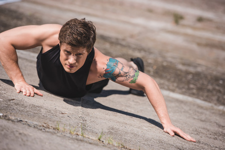 man exercising on slabs