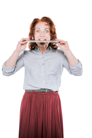 woman biting digital tabletの写真素材
