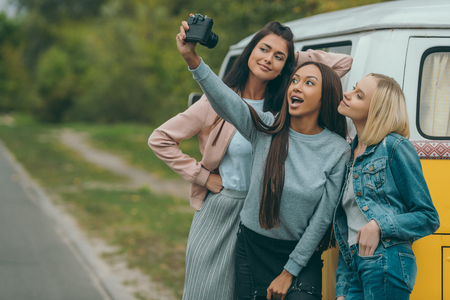 multiethnic friends taking selfie