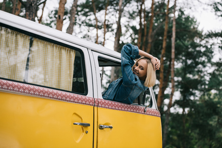happy girl in retro minivanの写真素材