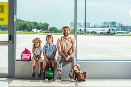 father and kids waiting for boardingの写真素材