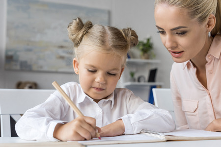 child drawing with motherの写真素材