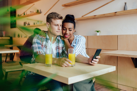 multiethnic couple using smartphoneの写真素材