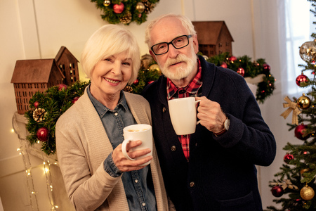 senior couple with coffee cupsの写真素材