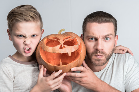 father and son with halloween pumpkinの写真素材