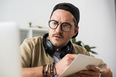 man writing in notebookの写真素材