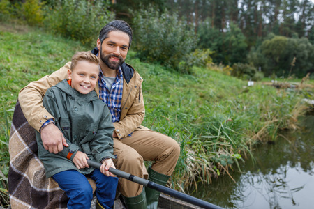 father and son fishing on pierの写真素材