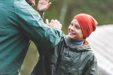 smiling family giving high fiveの写真素材