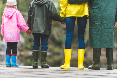 family standing on wooden bridgeの写真素材