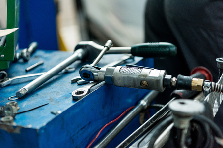 Close up of auto repair tools layed out on a table in a car service workshop.の写真素材