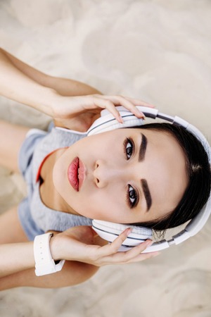 asian woman with headphonesの写真素材