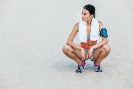 sportswoman resting with towelの写真素材