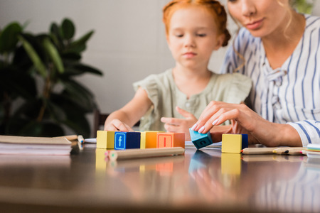 mother and daughter learning with letter cubesの写真素材