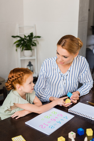 mother and daughter learning math at homeの写真素材