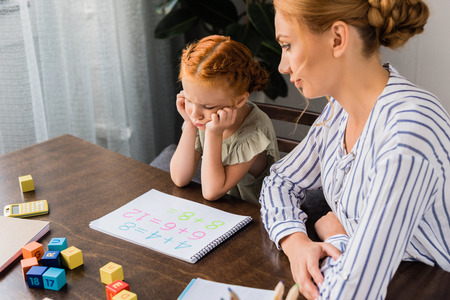 mother and depressed daughter learning mathの写真素材