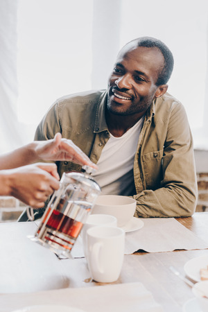 Smiling man having breakfastの写真素材