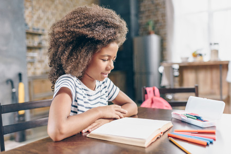 Little girl reading bookの写真素材