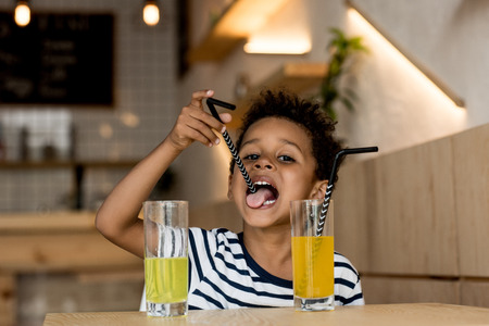 african american child drinking juiceの写真素材